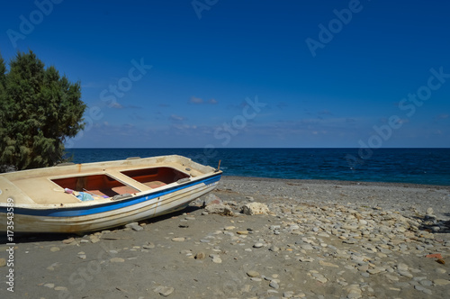 View of the pebble beach of Maleme with a boat