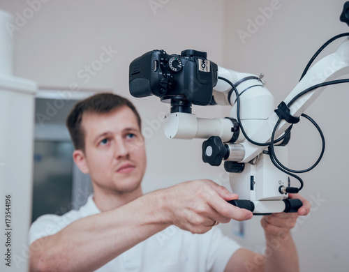 Microscope with photo camera in the dental office