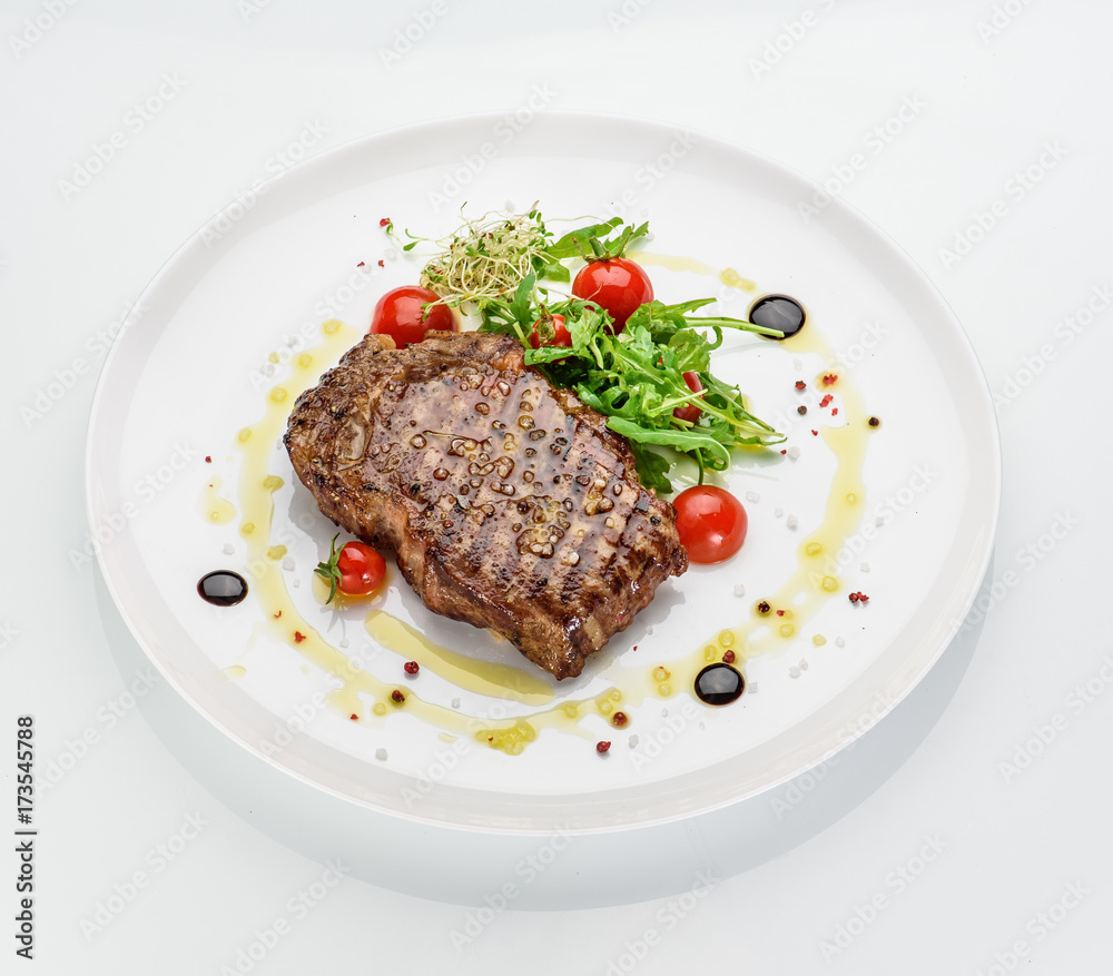 Marble stake with spicy herbs and sea salt over white background Marble stake with spicy herbs and sea salt over white background