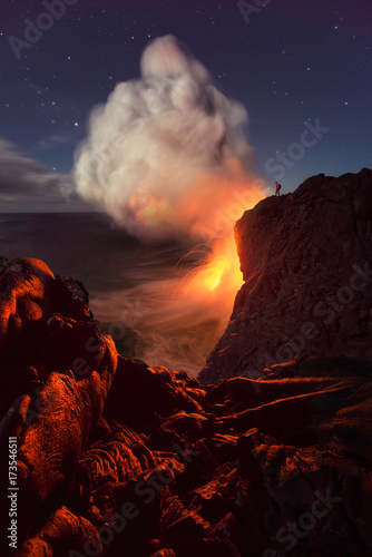 Volcano eruption flowing to the sea at night