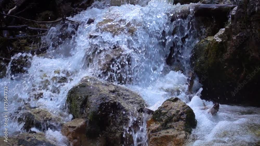 SLOW MOTION: flowing water over stones in mountines river SLOW MOTION: flowing water over stones in mountines river