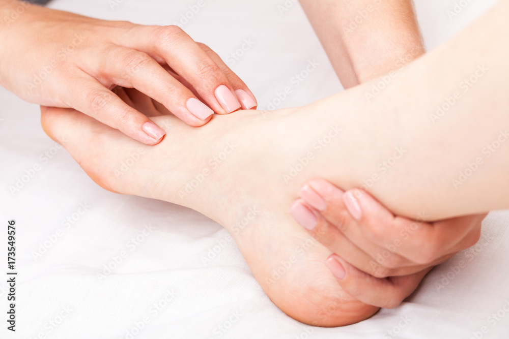Woman receiving osteopathic treatment of her foot joint