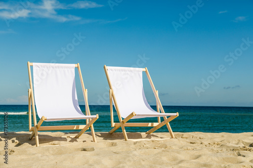 Valokuvatapetti Deck chairs on beach