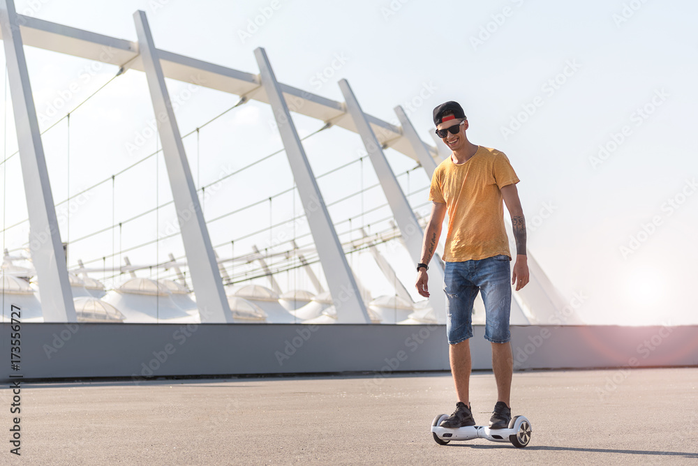 Cheerful boy riding on gyroscope