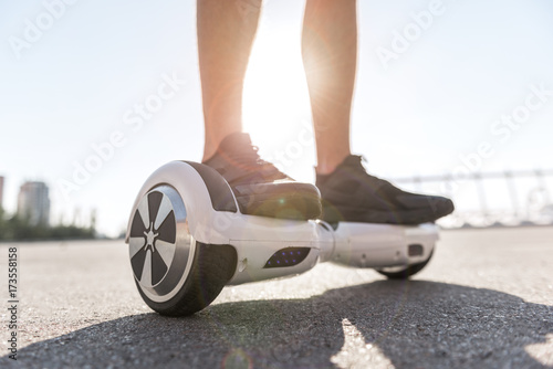 Man legs riding on gyroscope photo