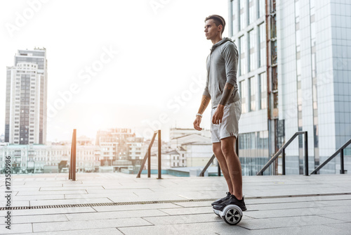 Serene teenager going on hoverboard