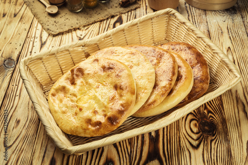 Traditional Georgian bread - khachapuri and Kolkh khachapuri on the table.Homemade baking. Flat lay, overhead.Khachapuri with cheese,georgian khachapuri megruli with cheese,Traditional Georgian pie photo