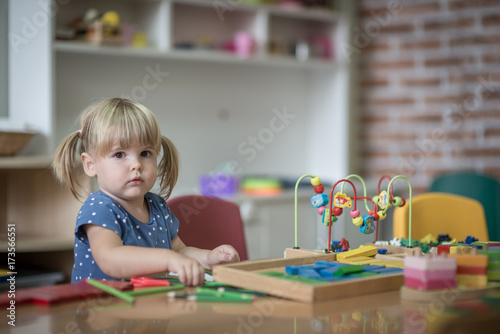 Portrait of confused little girl in kindergarten