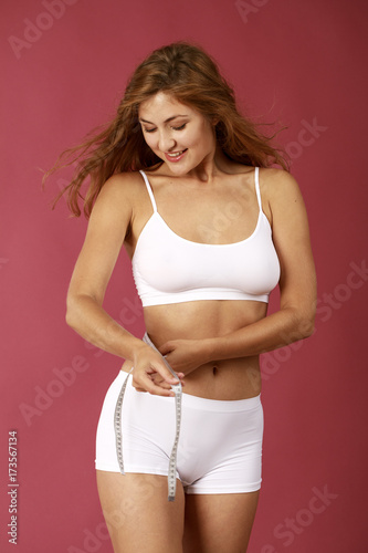 beautiful blonde woman in white fitness clothing © Andrey_Arkusha