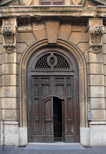 weatherbeaten old gate of apartment building