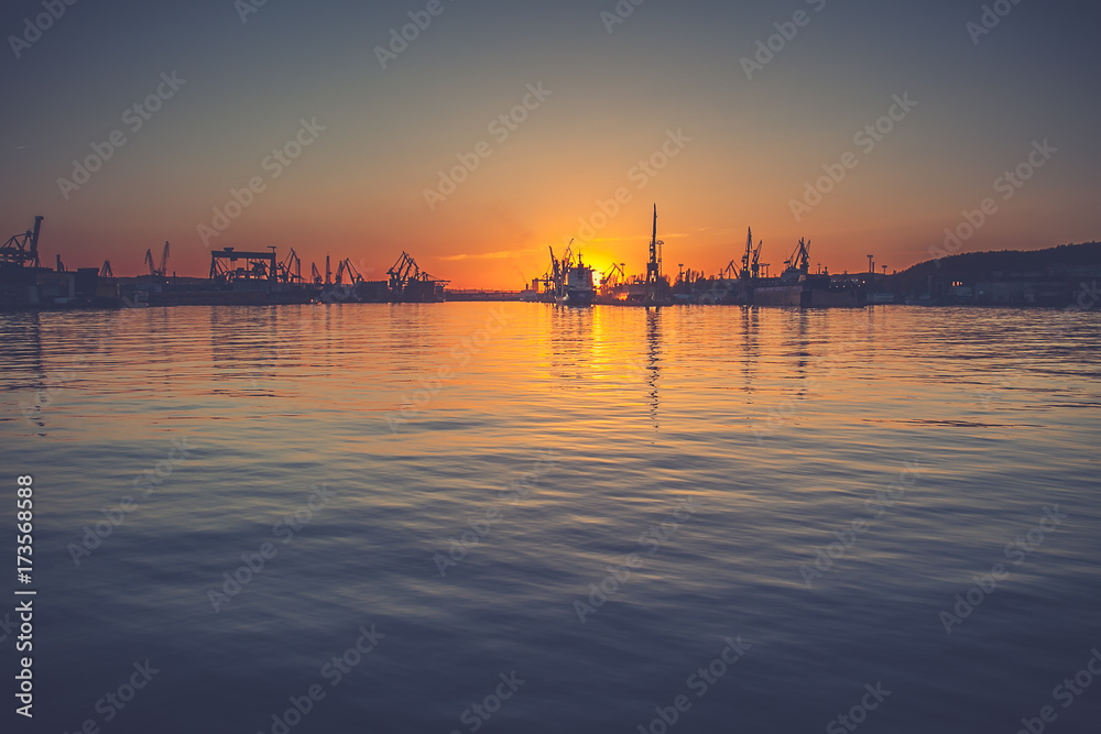 Amazing foggy sunrise over the shipyard in Gdynia