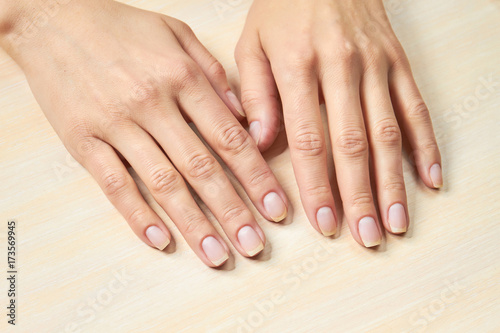 Female gentle hands. Woman beautiful hands on salon table. Woman hands in nails and spa salon.