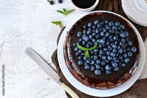 Homemade chocolate cake with cream and blueberries on a white background. Happy Birthday.