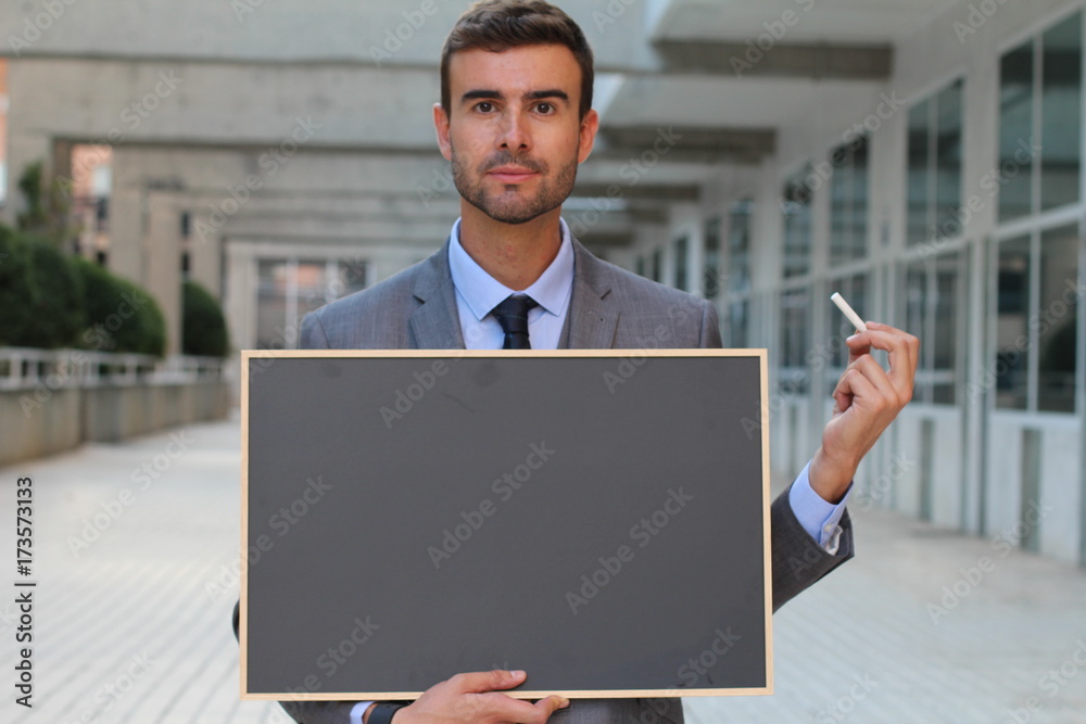 Businessman showing a blackboard with space for copy Businessman showing a blackboard with space for copy