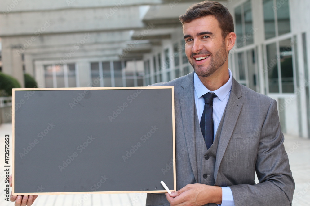 Businessman showing a blackboard with space for copy Businessman showing a blackboard with space for copy