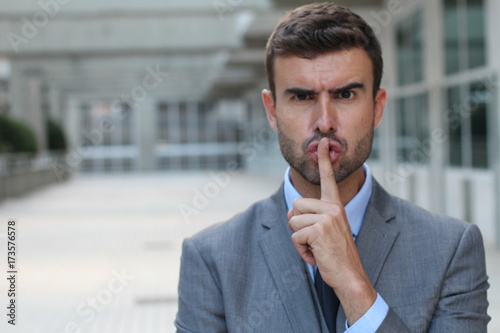 Angry businessman telling you to shut up photo