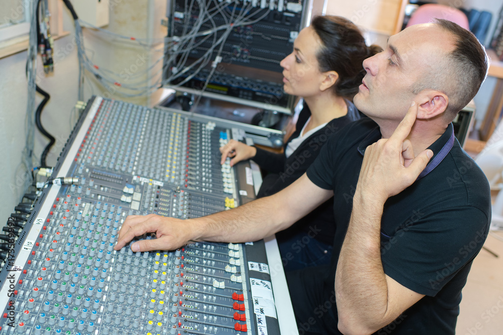 sound engineer and producer working together in studio sound engineer and producer working together in studio