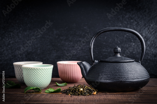 Green tea in cast-iron teapot