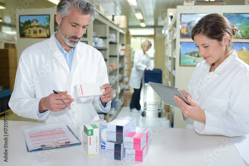 female pharmacist and pharmacy technician posing in drugstore photo