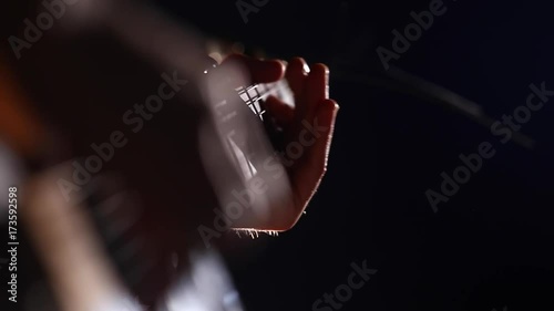 Musician Playing calm guitar solo on a dark background close-up photo