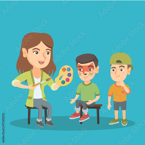 Young caucasian woman makeup artist painting the face of a little boy for a party. Visagiste drawing a cat makeup on the face of a boy. Vector cartoon illustration. Square layout.
