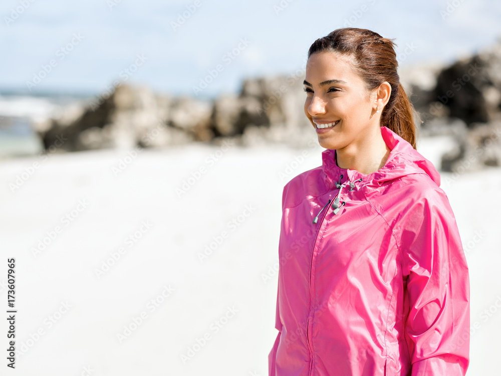 Athletic woman in sportswear standing at the seaside Athletic woman in sportswear standing at the seaside