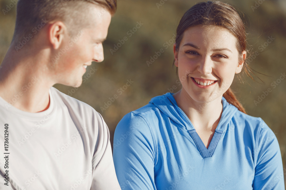 Young couple on beach in sportwear Young couple on beach in sportwear