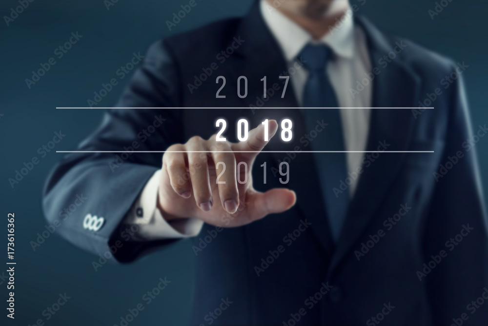Businessman pointing year 2018. Business new year card concept. Businessman pointing year 2018. Business new year card concept.