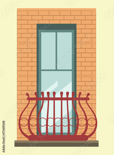 Tall window with small elegant balcony in brick wall