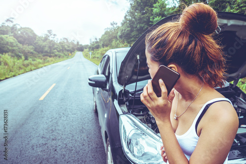 Asian women travel relax in the holiday. Broken car on the street. Thailand