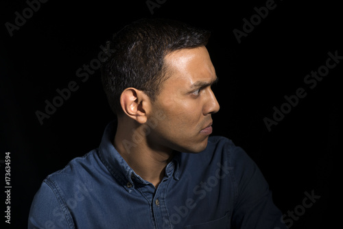 Man in Denim Shirt Looks to the Side Feeling Annoyed