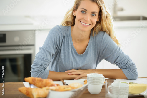 french woman having breakfast at home