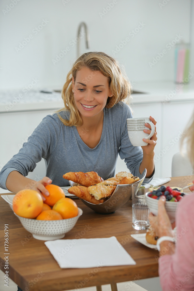 mother and daughter having french breakfast mother and daughter having french breakfast