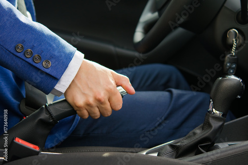 the man sets the car to the handbrake, lifting it to the top