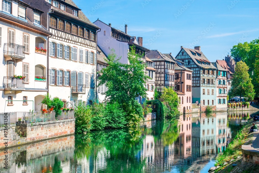 Typical house near water and flowers from La Petite France in Strasbourg, Alsace, France