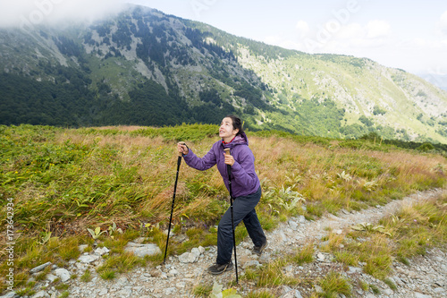 Smiling woman rocky mountain hiking