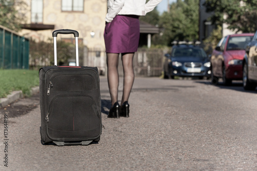 woman with travel bag on the street, getting ready for jorney.