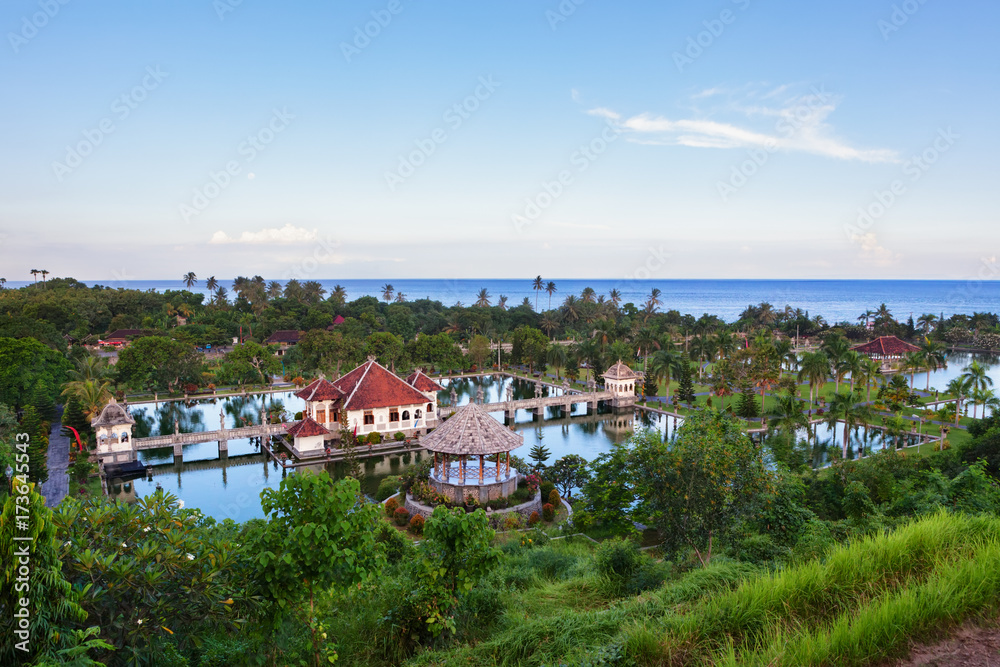 Aerial view of Taman Ujung water palace near Alampura in Karangasem on Bali Island. Ancient palace of Balinese royal family with water pools and tropical landscape park. Indonesian art and culture.
