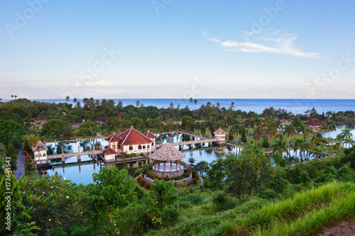 Aerial view of Taman Ujung water palace near Alampura in Karangasem on Bali Island. Ancient palace of Balinese royal family with water pools and tropical landscape park. Indonesian art and culture. © Tropical studio