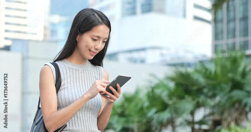 Woman using smart phone in street Woman using smart phone in street