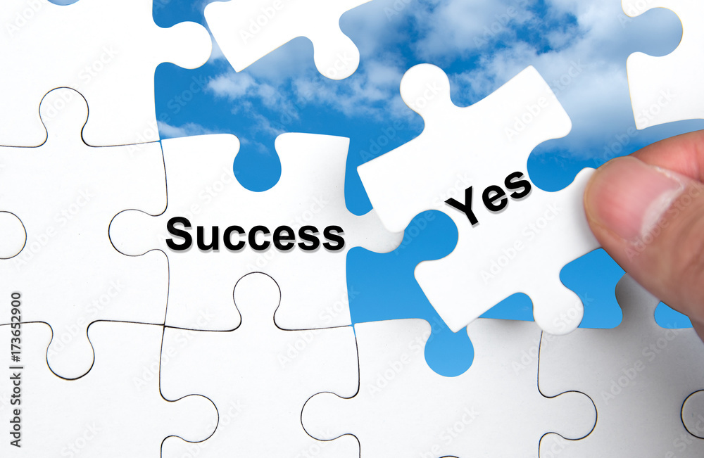 White jigsaw puzzle with Success and Yes word, business concept. White jigsaw puzzle with Success and Yes word, business concept.