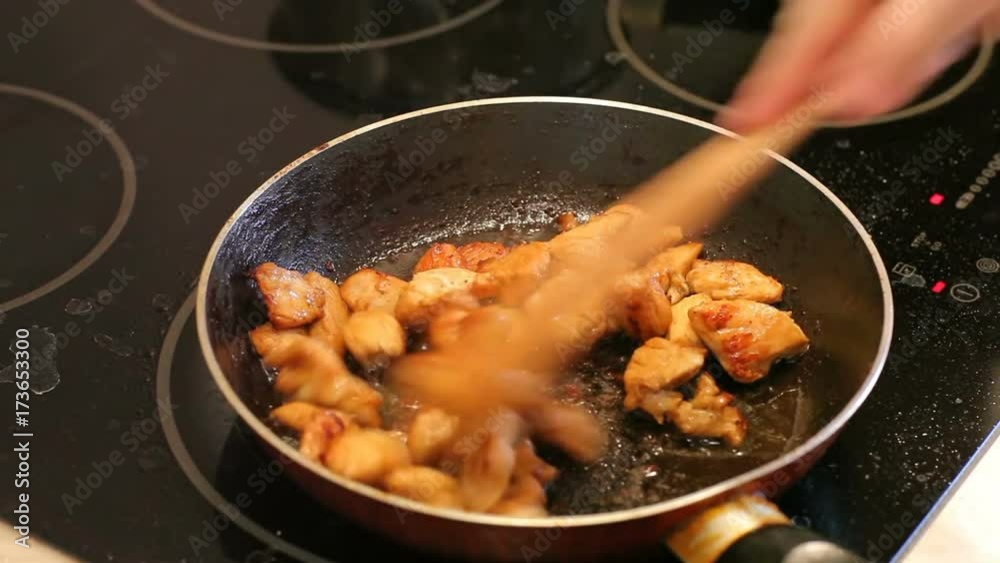 Chicken is fried in a pan Chicken is fried in a pan