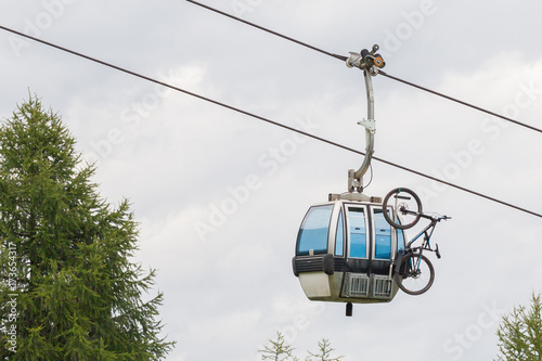 Ski lift cable booth or car with a mountainbike on the side (unmarked)