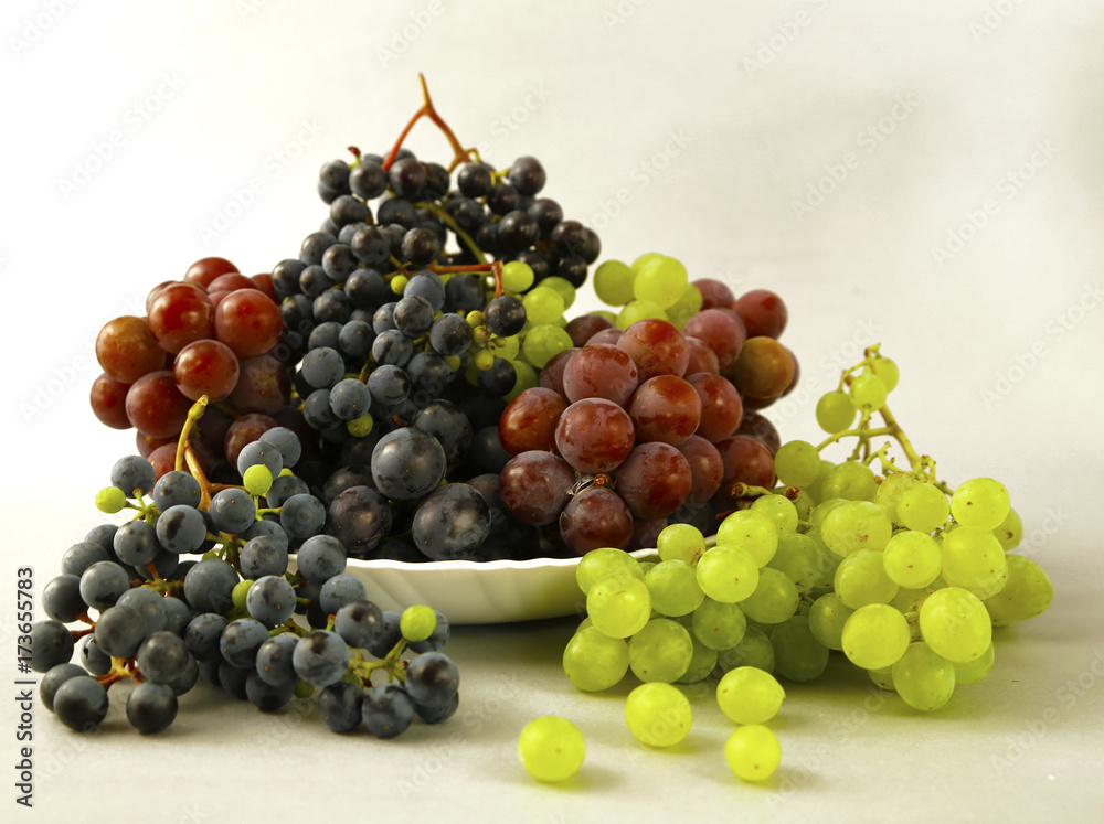 juicy grapes or a frame with grape on the white juicy grapes or a frame with grape on the white