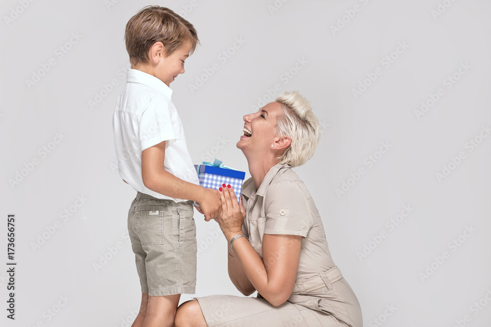 Fototapeta premium Mom posing with young son, smiling.