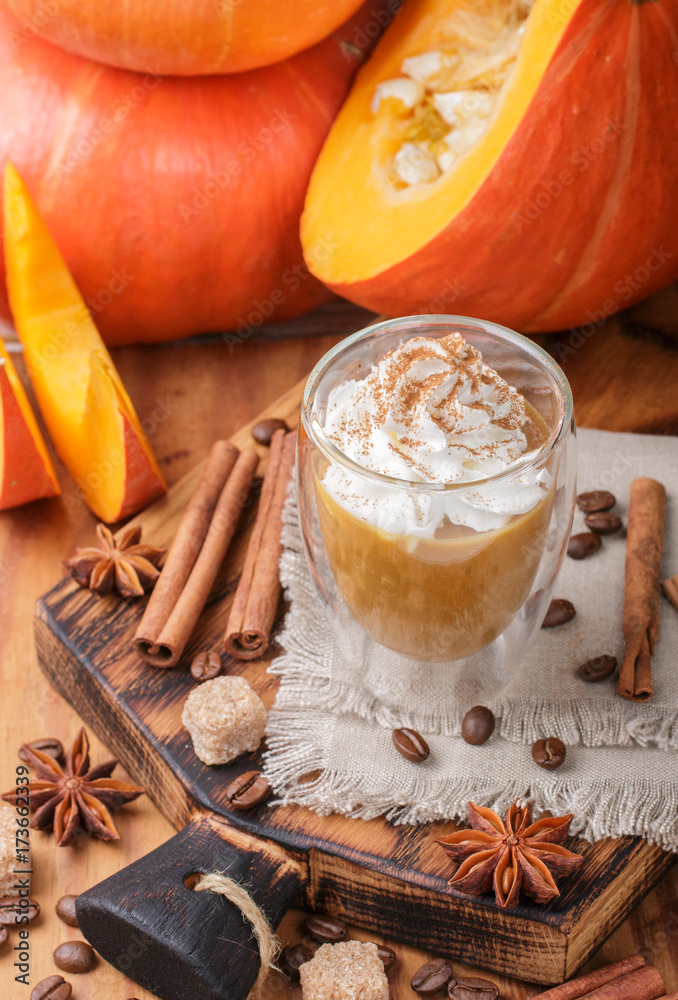 Pumpkin latte or cocktail (smoothie) with spices - cinnamon, anise, coffee. Hot or cold fall drink. Selective focus
