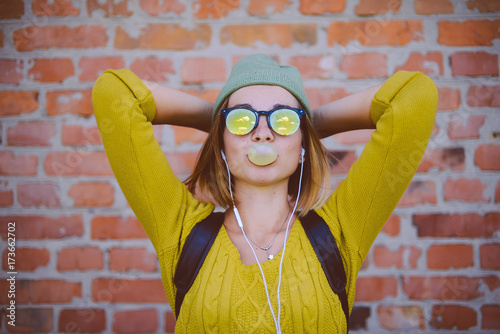Portrait of a beautiful young hipster girl with  sunglasses