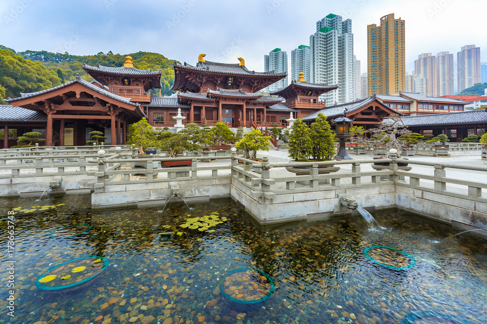 Mahavira Hall in Chi Lin Nunnery, a large Buddhist temple complex built without a single nail, in Diamond Hill with modern buildings in the background, Kowloon, Hong Kong