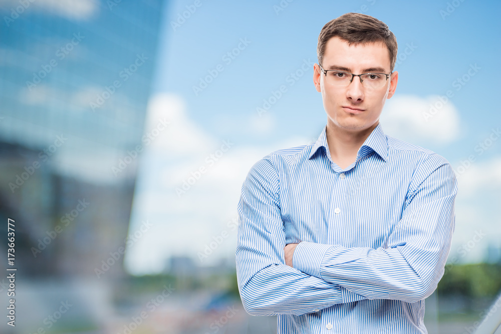 Businessman in glasses young and very successful, in office Businessman in glasses young and very successful, in office