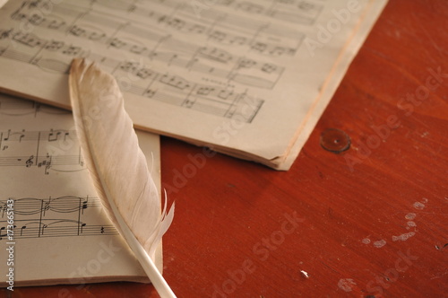 Notes and feather on the table